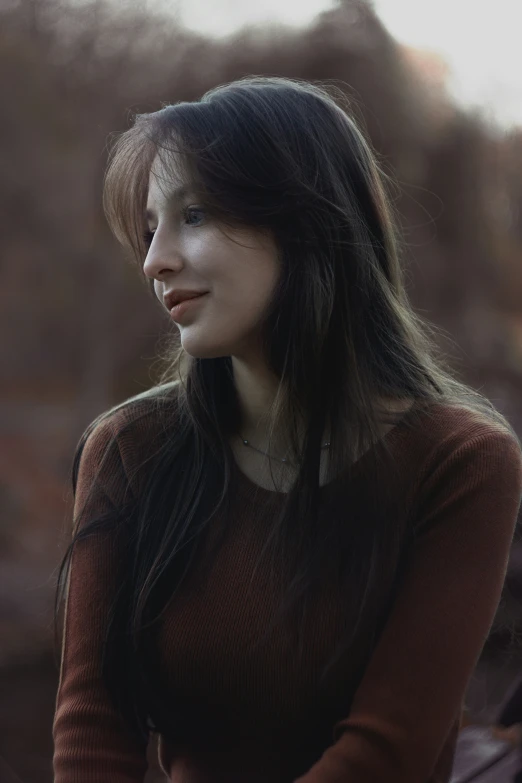 a woman sitting down with her eyes closed