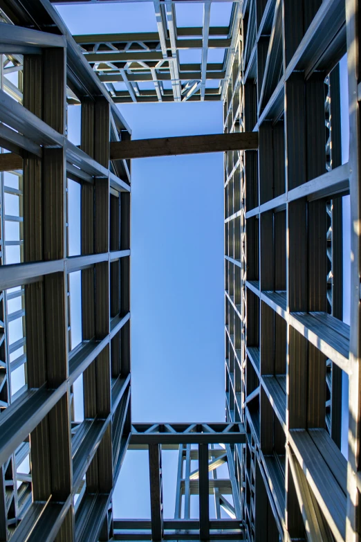 a bunch of wood shelves that have a blue sky