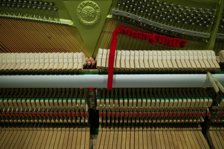 a piano that has a red string on it