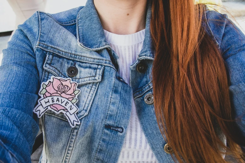 a woman is wearing a denim jacket and has pigtails in her hair