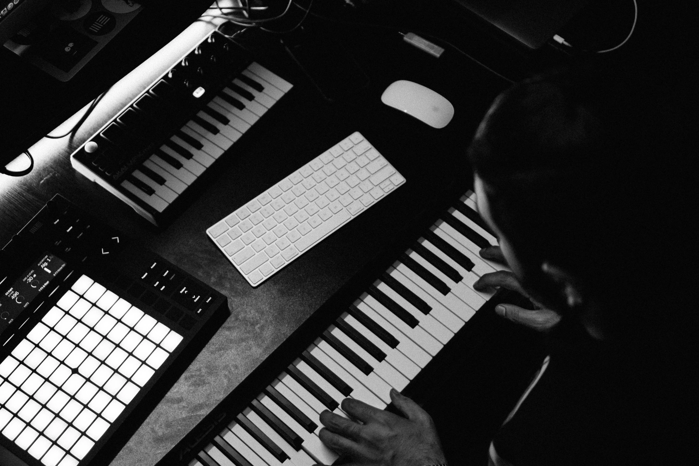 a man using an electronic keyboard in the dark