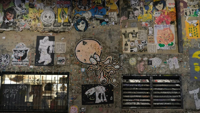 the wall is covered with various graffiti and pictures