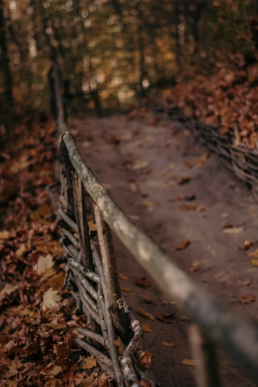 an old fence that is next to a path