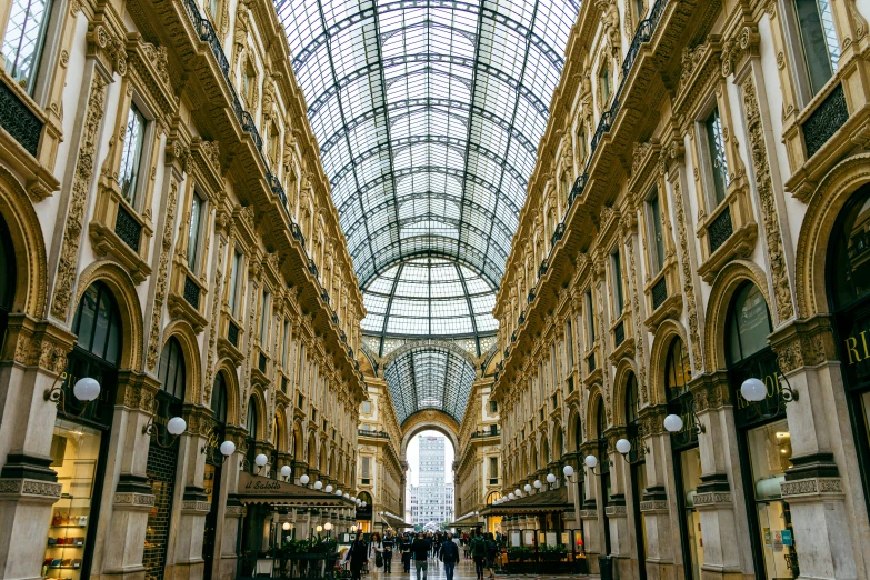 a walkway inside of a large building filled with lots of people