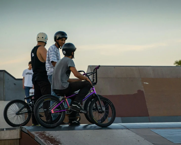 some people and a bike at a skate park