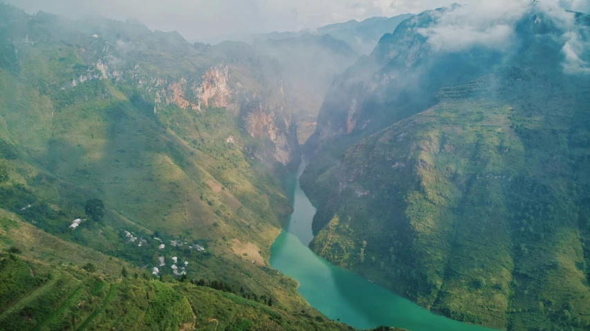 a valley covered with lots of trees and a river