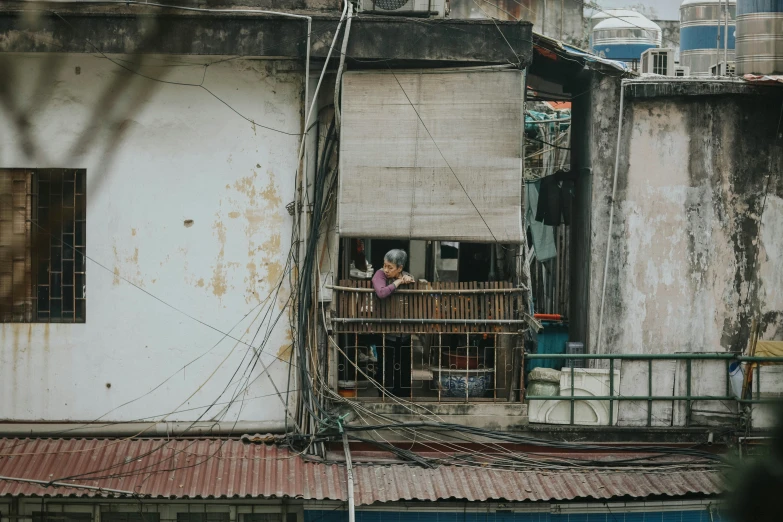 a person on top of a balcony overlooking a building