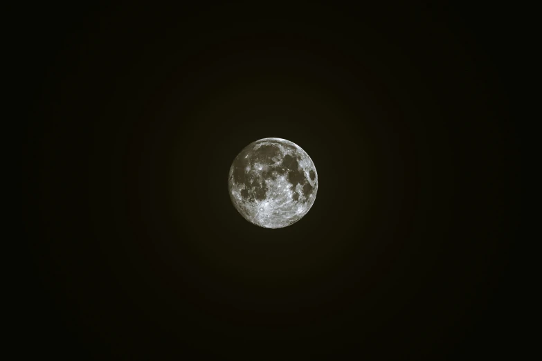 the moon has a dark black background in the night sky