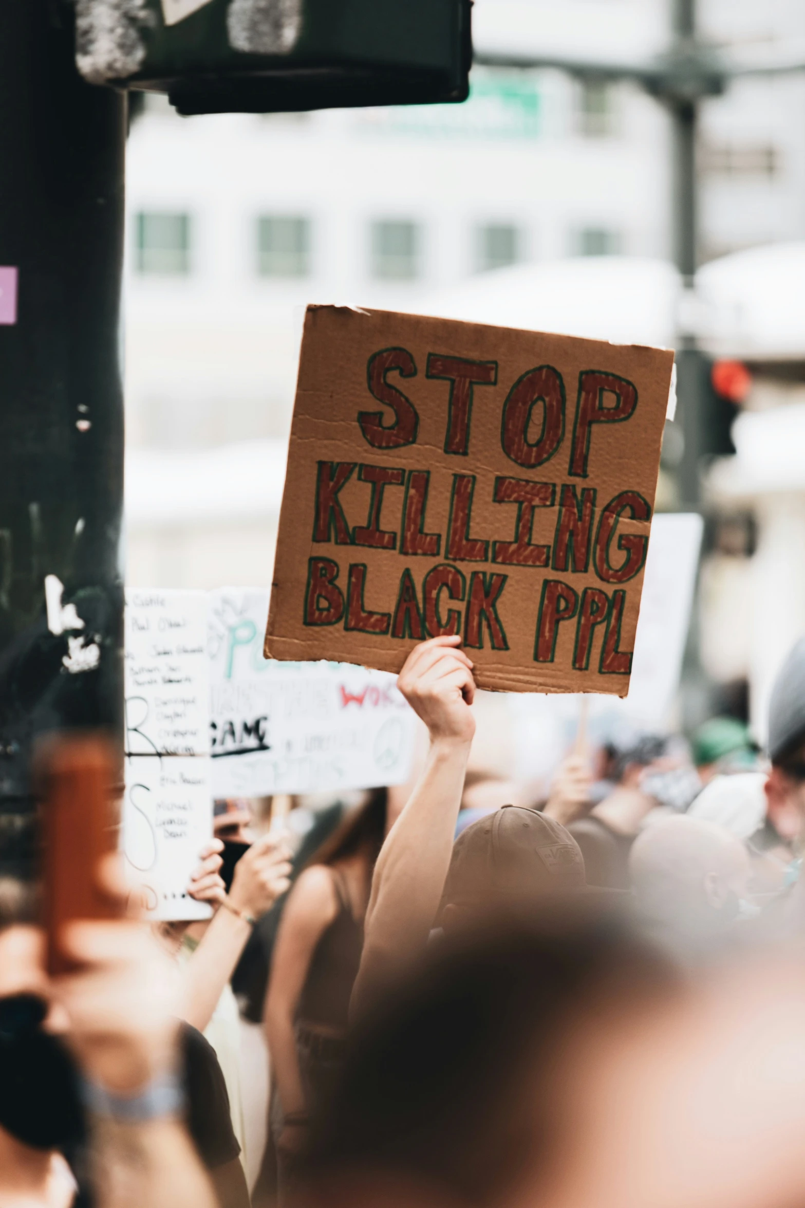 the protesters are holding up signs reading stop ing black protesters