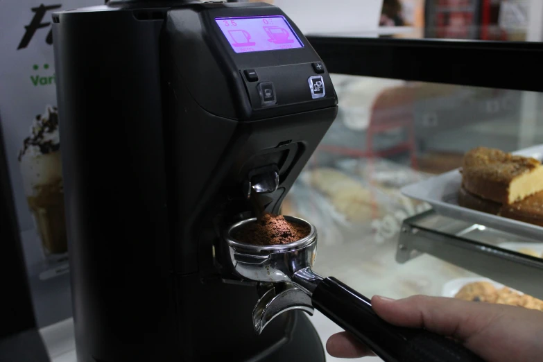 coffee machine with grinder and coffee cups on display