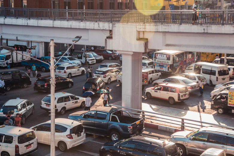 cars and motorcycles stopped at an intersection in the city