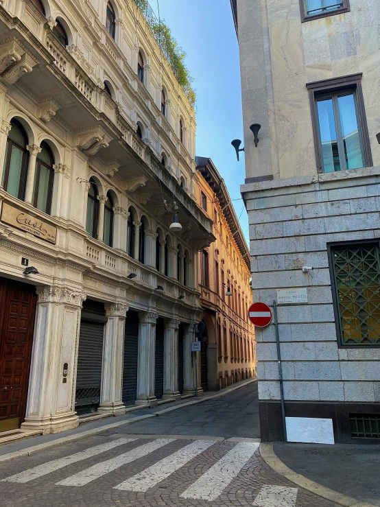 two buildings one with a street light and the other one with a red traffic light