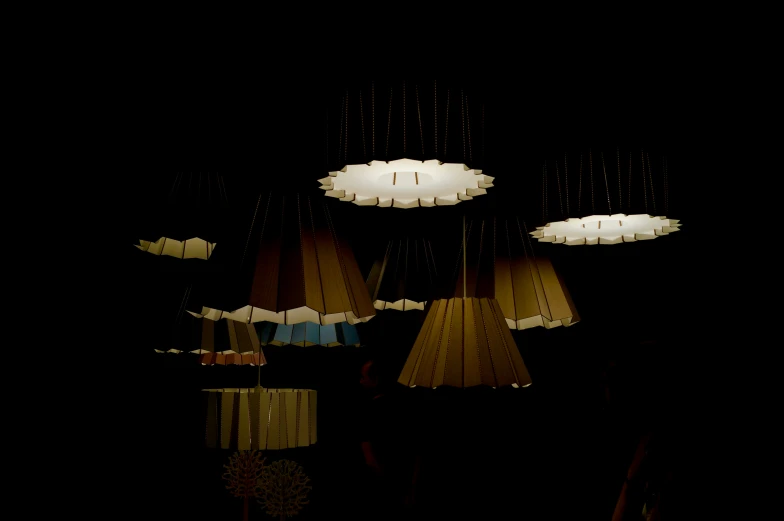 a row of lamps that are lit on a black background