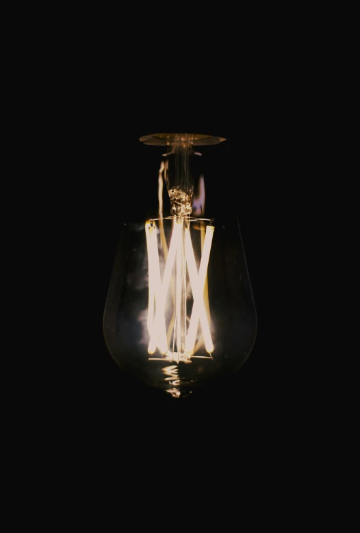 a light bulb with a dark background on top of it