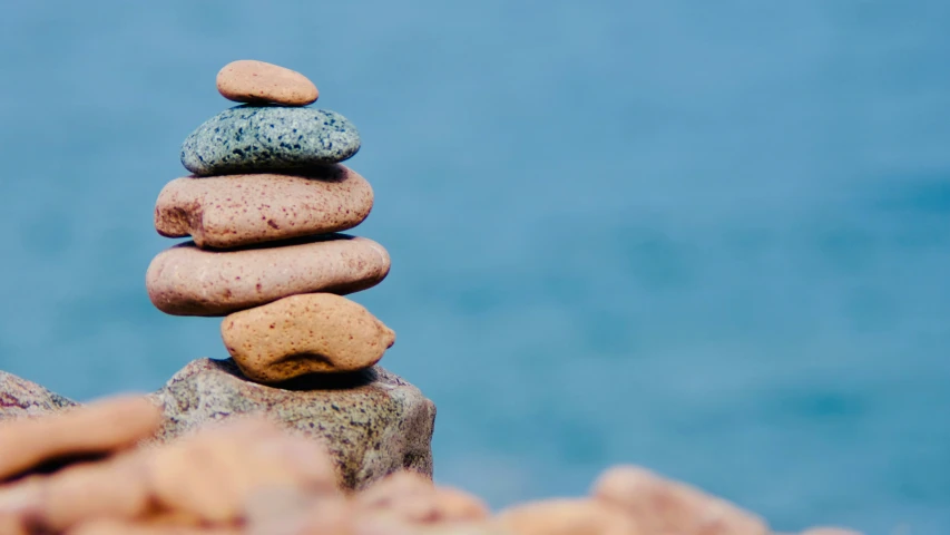 rocks stacked into each other by the ocean