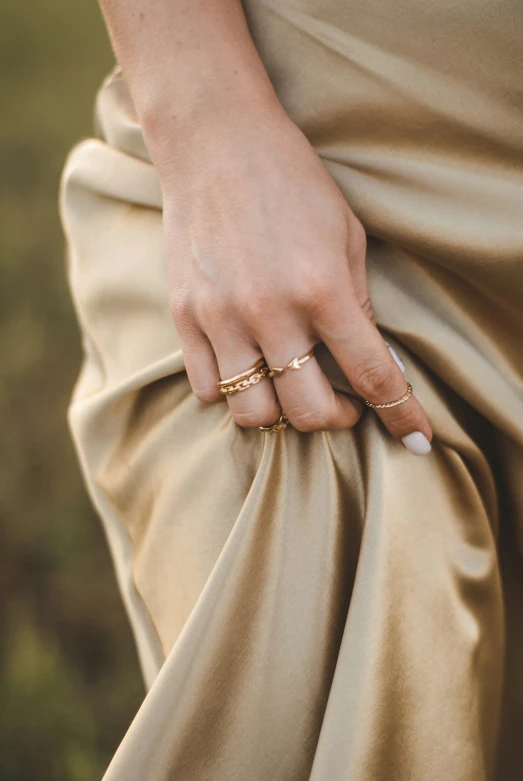 close up view of the side of a woman's dress with her ring on it