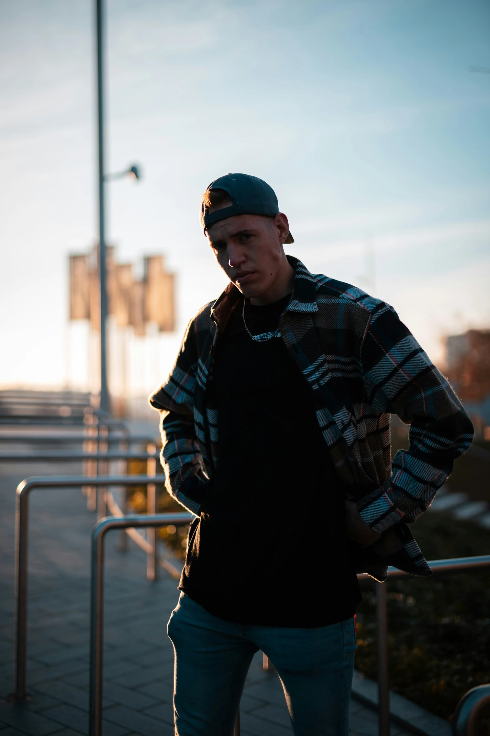 a man standing in the sunset on a skateboard