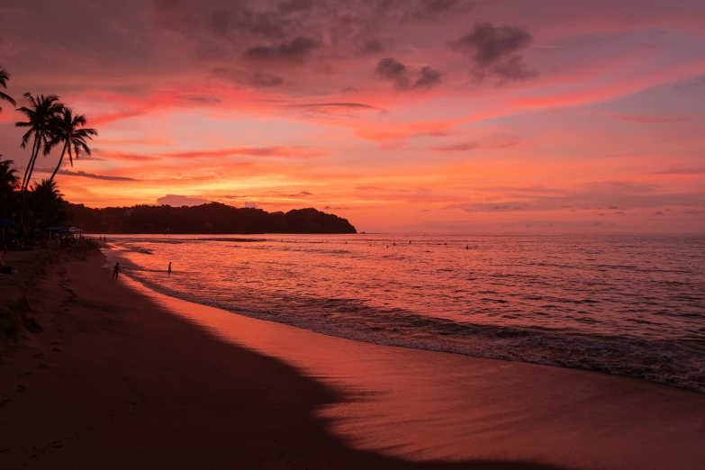 the sky above the ocean has pink clouds