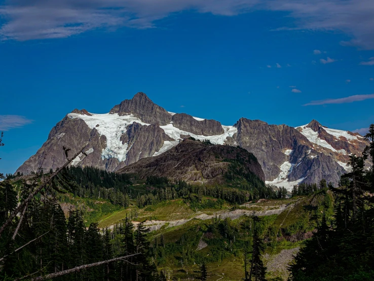 there are mountain peaks with some snow on them