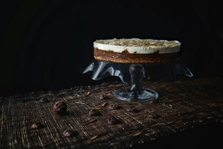 a cake sitting on a table covered with nuts