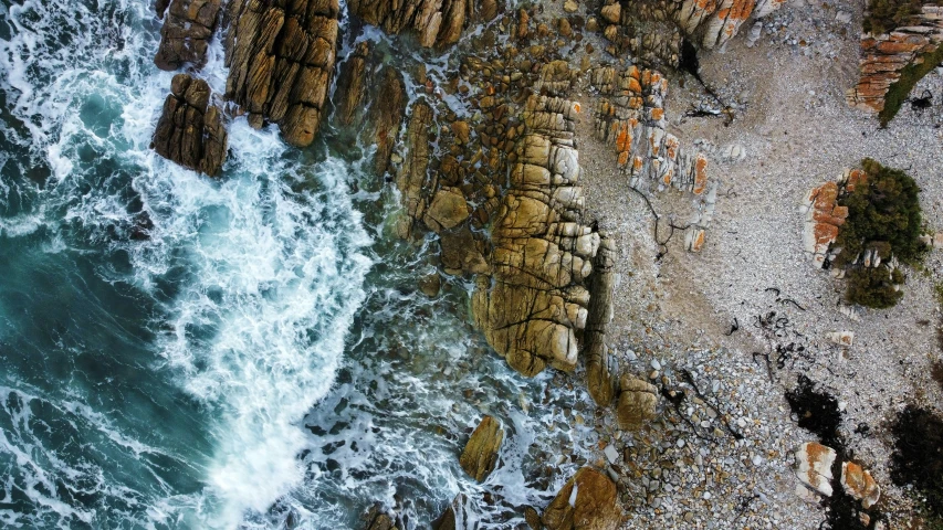 the rocky coastline is shown from above looking down