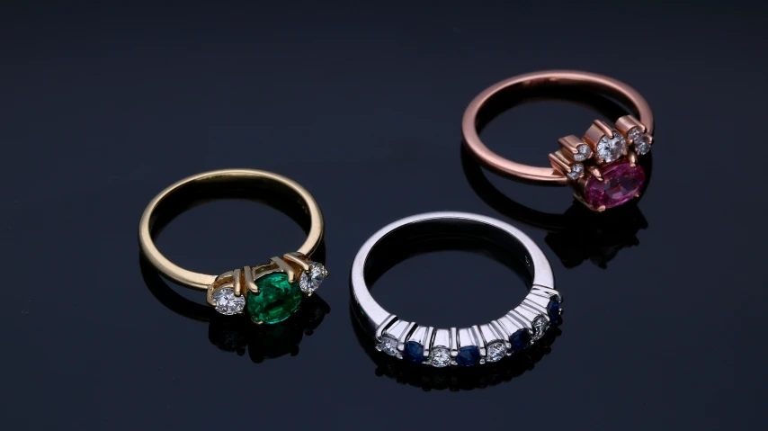 three different colored and shaped diamond rings