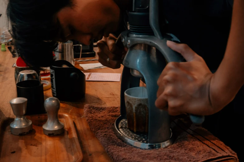 a man with a coffee press on a counter top