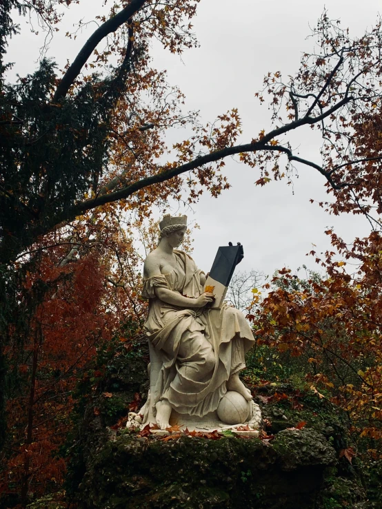 statue of person holding a flag and eating a cup