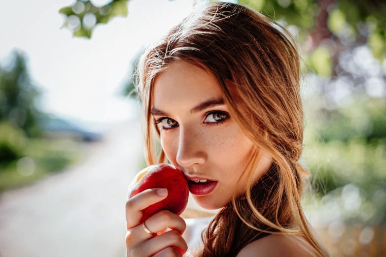 an image of a woman holding an apple in her hand