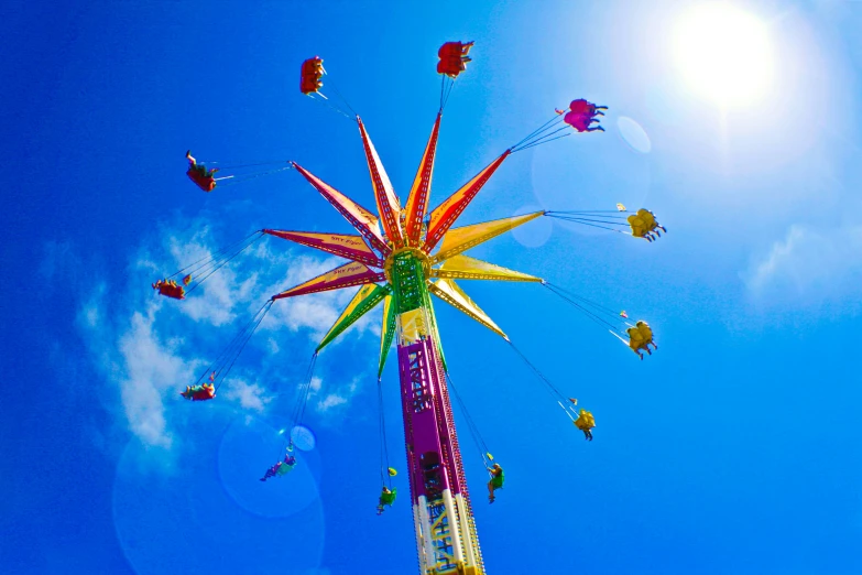 an amut ride in the air with people flying in the background