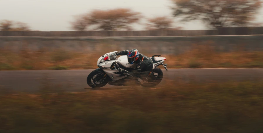 a man riding on the back of a white motorcycle