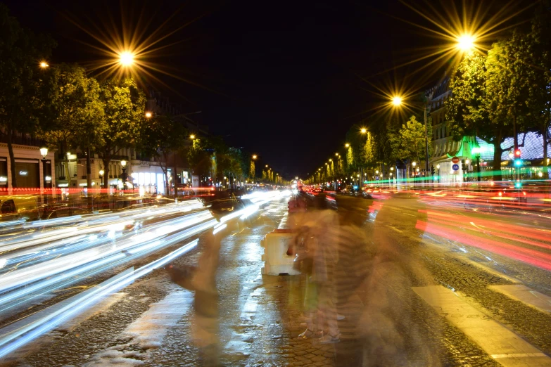 several cars driving down the street at night