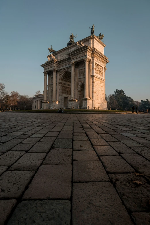 the stone pathway in front of a white arch