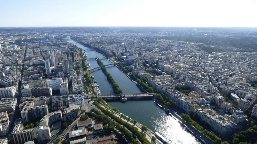 a river flowing through a city next to a tall building