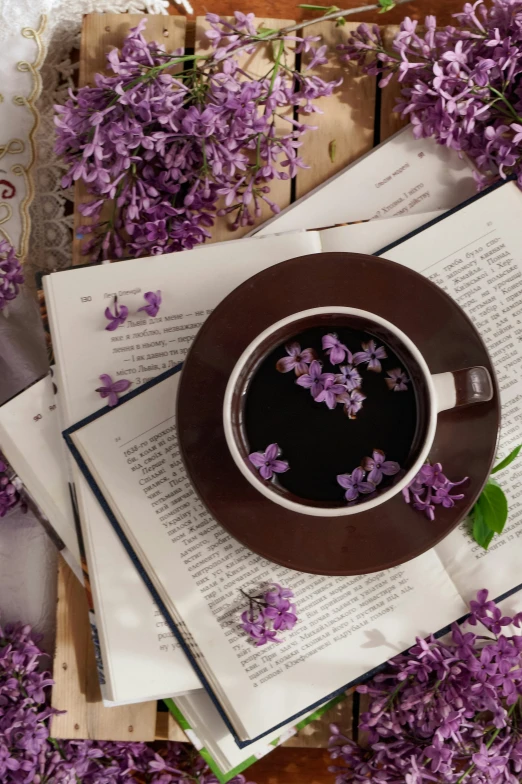 a coffee cup and saucer is on a book