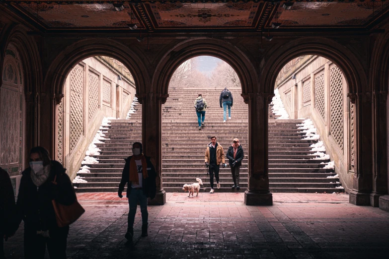 a couple of people that are standing in front of some stairs