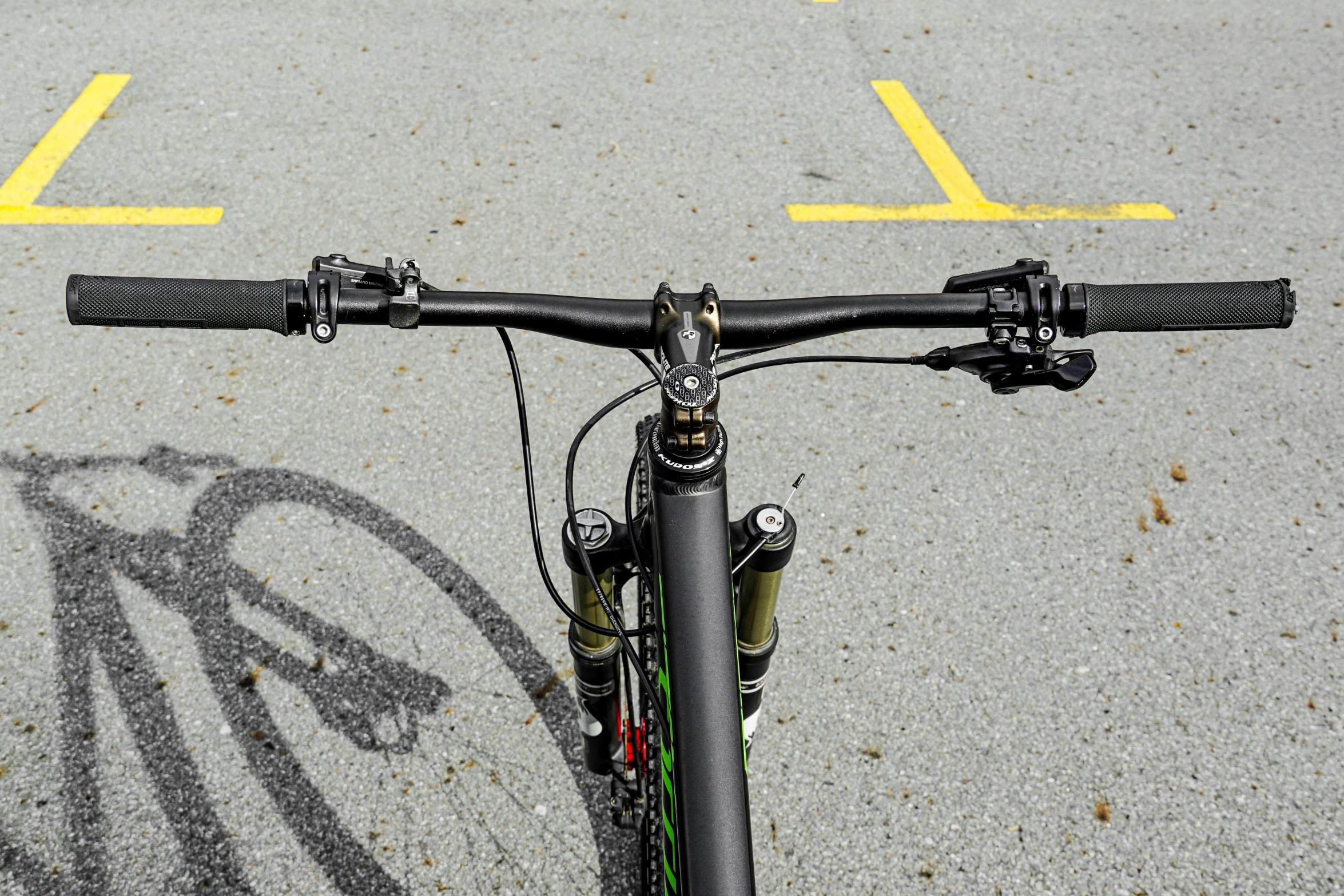 a bicycle in the road with a yellow line behind it