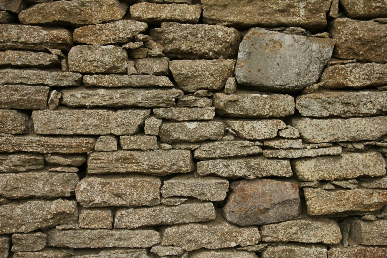 a brick wall is piled high with various rocks