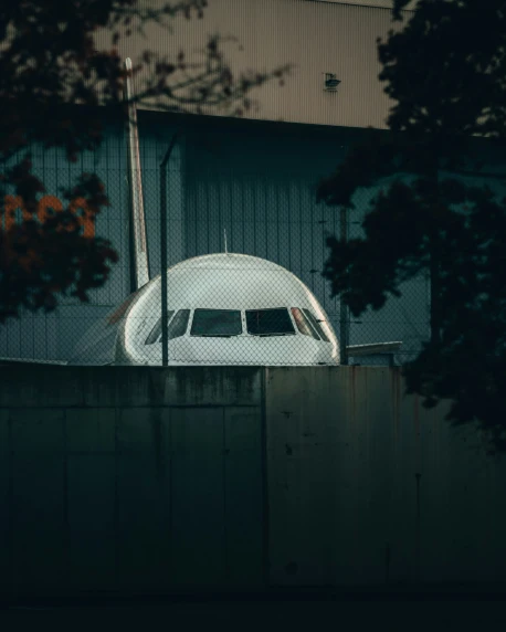 this airplane is parked in an enclosure under a building