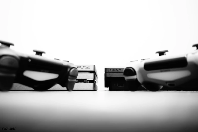 three video game controllers sit side by side on a table