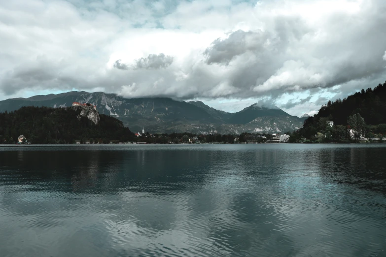 an island is shown in the distance under clouds