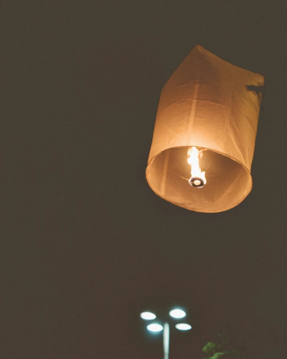 a lamp post and lights in a dark sky