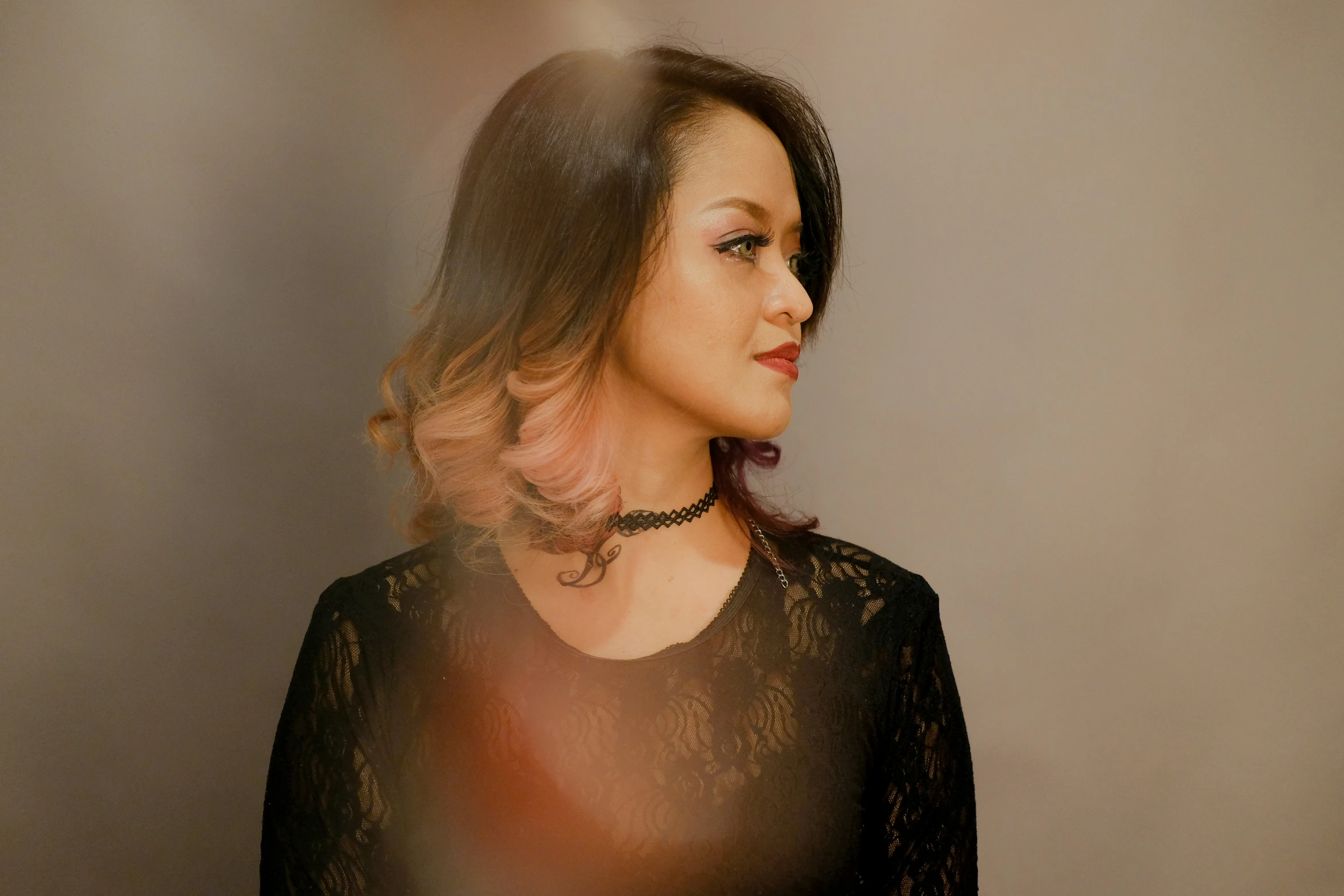 a woman is staring straight ahead with the camera flash reflected off of her chest