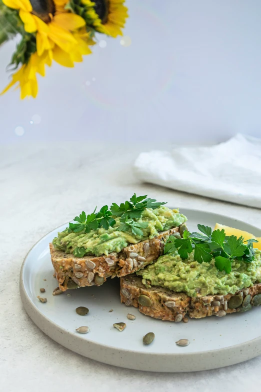 a plate with some ers topped with guacamole