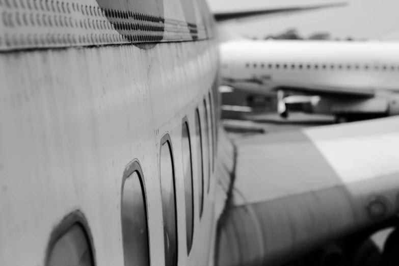 the backside of an airplane parked in front of other airplanes