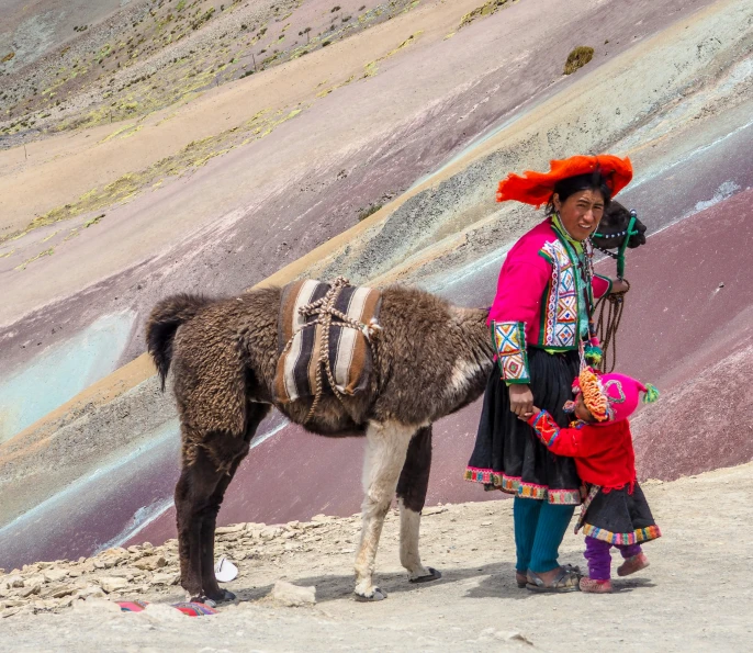 a woman with her child and a donkey