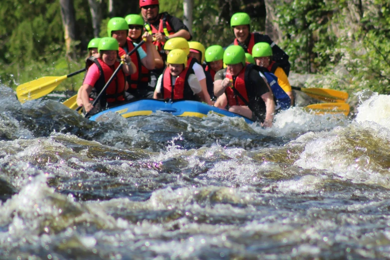 a group of people rafting down a large river