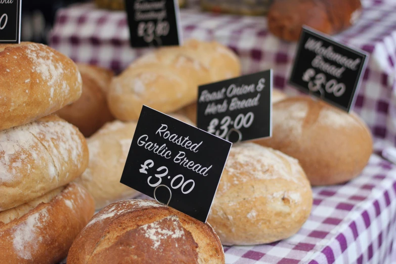 several varieties of bread sit on display for sale