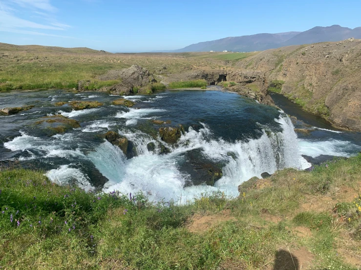 a small waterfall flows over a small stream