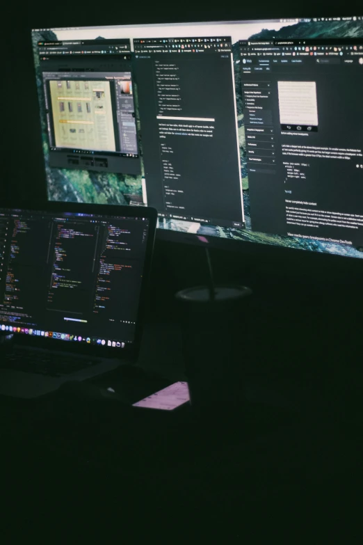 a desktop computer in the dark on top of a desk